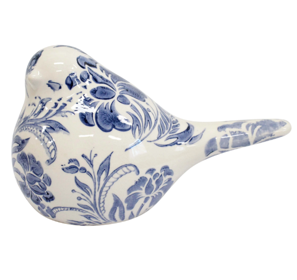 Blue and white ceramic bird figurine with floral pattern detail