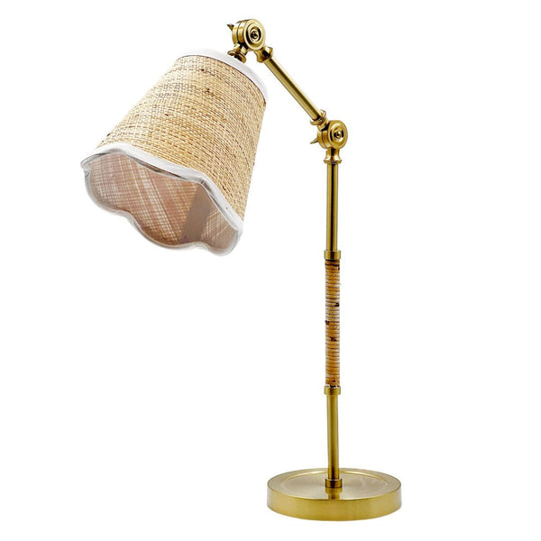 Wallace Raffia Table Lamp with polished brass base, adjustable neck and handcrafted natural raffia shade with white trim.
