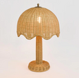 Rattan table lamp illuminated showing warm ambient woven light
