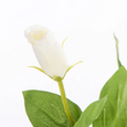 Close-up of realistic white faux lisianthus bloom with soft layered petals and green foliage.