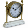 Angled view of the White Marble & Gold Column Mantel Clock showing its polished gold metal frame, decorative finials, Roman numeral dial and white marble base.