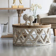 Round coffee table with weathered white lattice detailing and whitewashed wood top viewed from an angle