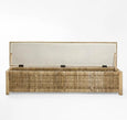 Rattan bench with lift-up lid showing internal storage compartment for blankets and cushions