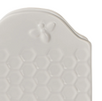 Close-up of the Wildflower & Hive Napkin Holder White showing embossed honeycomb texture and decorative raised bee detail.