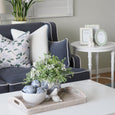Paume Whitewash Rattan Rectangle Tray styled on a coffee table in a blue and white Hamptons living room.