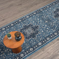 Traditional blue and navy Windsor runner rug styled with timber side table on wood flooring