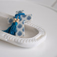 Zara Marble Tray White styled with a blue and white decorative cross and tassel