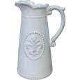 Tall off-white ceramic jug with embossed fleur-de-lis detail and curved handle