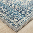 Rectangular Bridgeport Blue rug with classic distressed blue and ivory pattern, shown on a timber floor