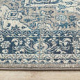 Rectangular Bridgeport Blue rug with classic distressed blue and ivory pattern, shown on a timber floor