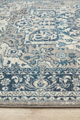 Rectangular Bridgeport Blue rug with classic distressed blue and ivory pattern, shown on a timber floor