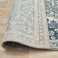 Rectangular Bridgeport Blue rug with classic distressed blue and ivory pattern, shown on a timber floor