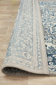 Rectangular Bridgeport Blue rug with classic distressed blue and ivory pattern, shown on a timber floor