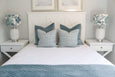 Callie Cushion Soft Blue Hamptons Style Cushion on a bed