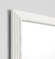 White rectangular wall mirror with bamboo-inspired stepped frame styled in a Hamptons-style interior