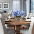 Blue hydrangea bundle styled in a glass bowl on a round dining table in a Hamptons style home