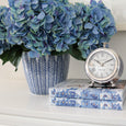 Blue hydrangea bundle styled in a blue and white ceramic pot