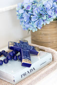Blue hydrangea bundle styled in a rattan pot with other decor items in a Hamptons style home