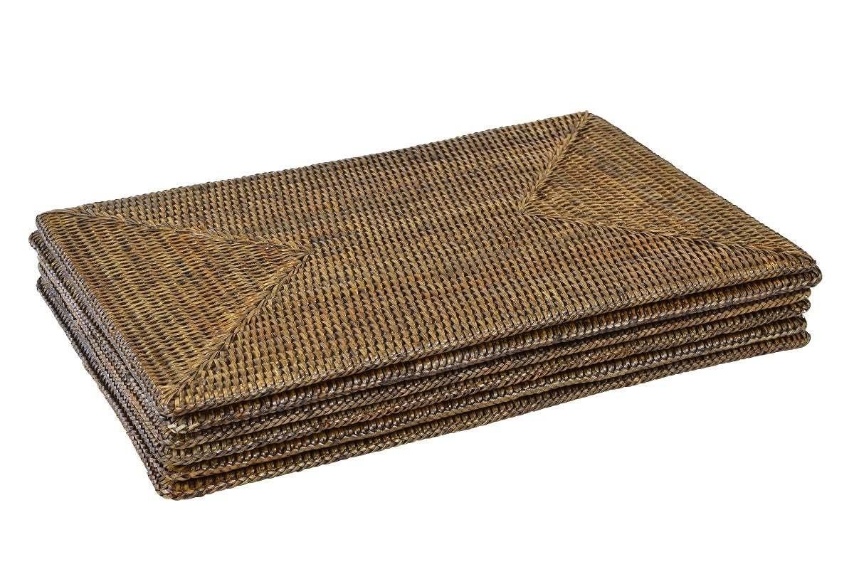 Stack of rectangular handwoven rattan placemats in natural finish