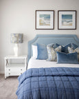 Rodeo Ocean Rectangle Cushion in dusky vintage blue velvet with white piping, styled on coastal Hamptons bed setting